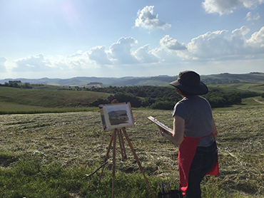 Artist in front of her painting during Walk the Arts art retreats in Italy and painting holidays in Tuscany