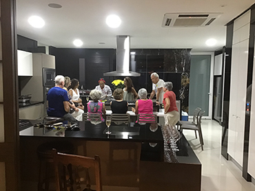 Group attending a cooking demonstration during Walk the Arts art workshop in South America